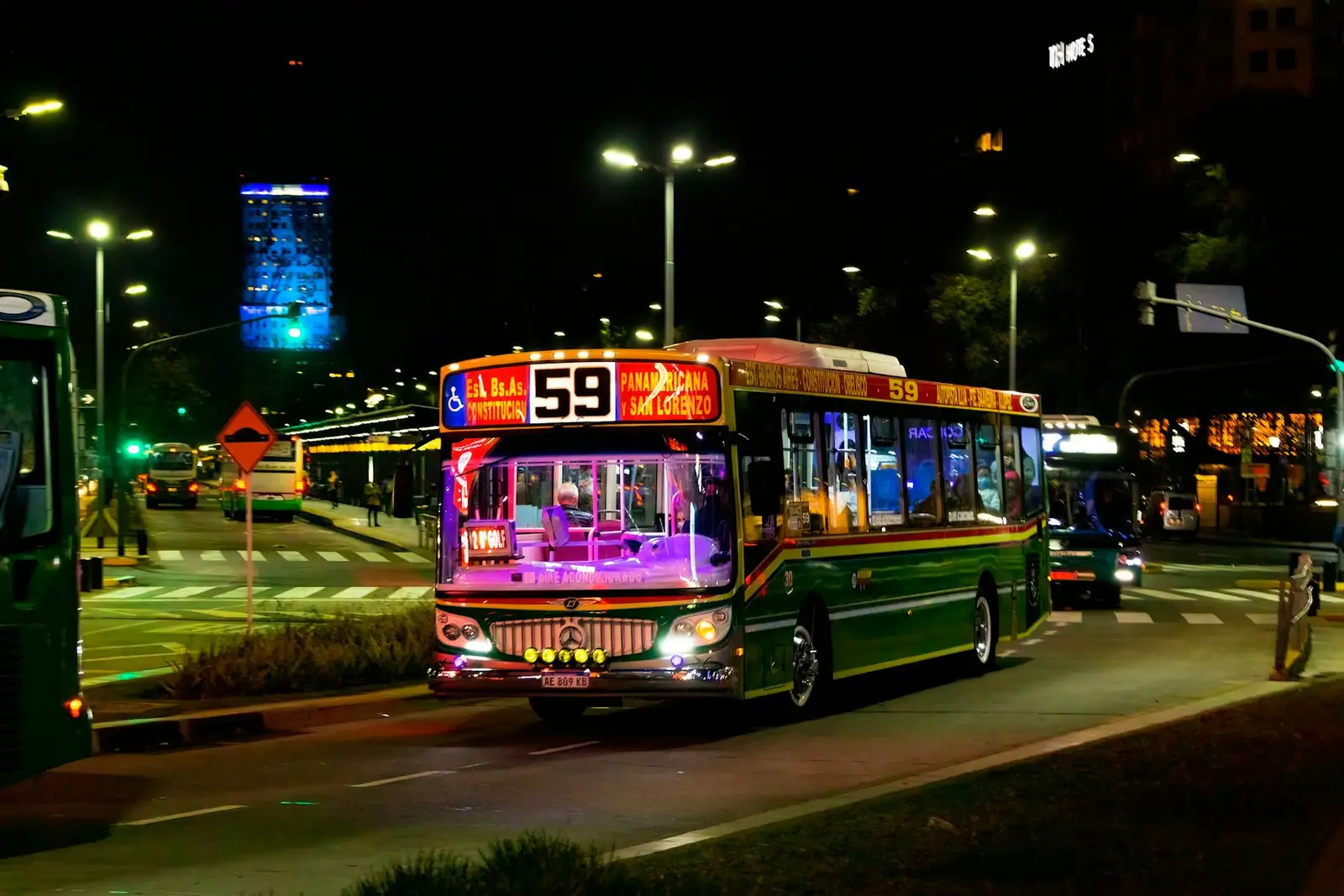 A city bus at night on a Buenos Aires avenue